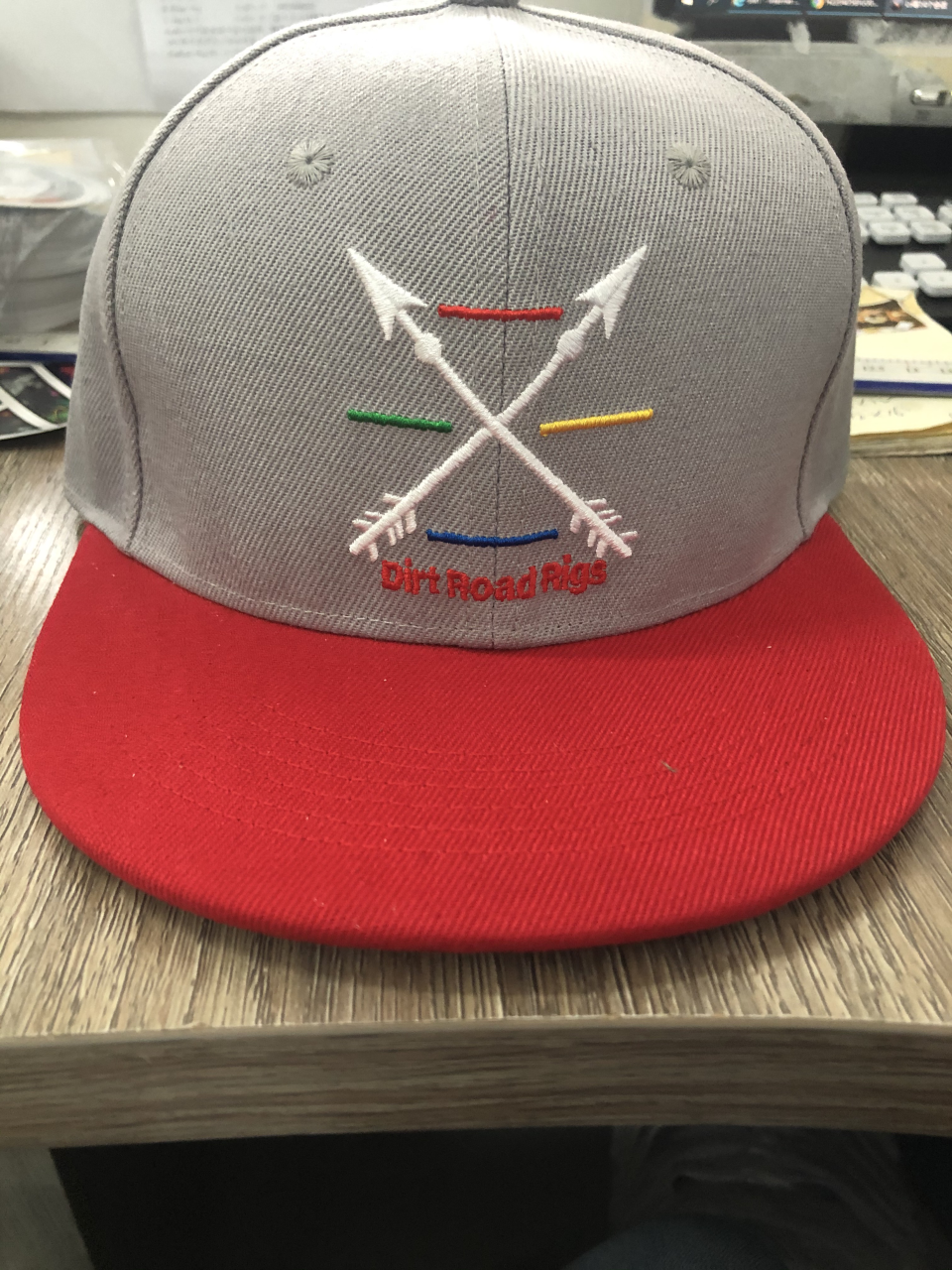 First Responders 4 Line (Red-Fire, Blue-Police, Green-Armed Forces, Yellow-EMS) Arrows Hat. 6 panel, flat bill, snap back in gray & red